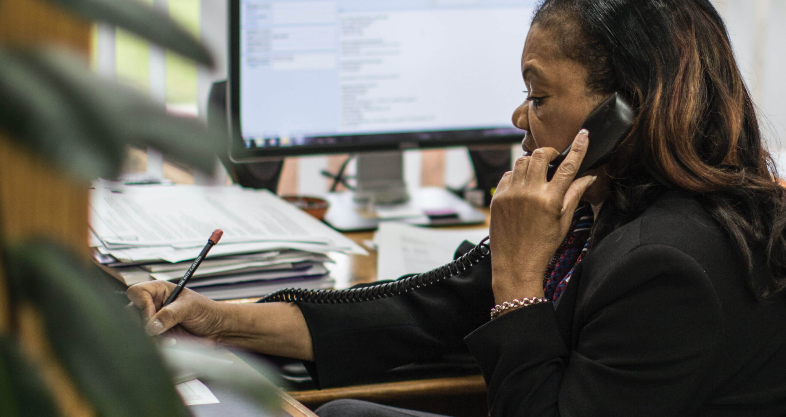 An RCC team member fields a phone call while taking notes