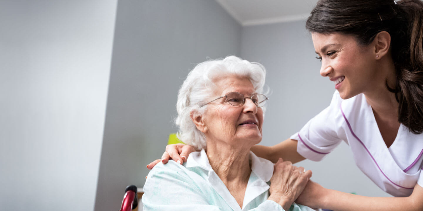 A young nurse tends to the needs of an elderly patient