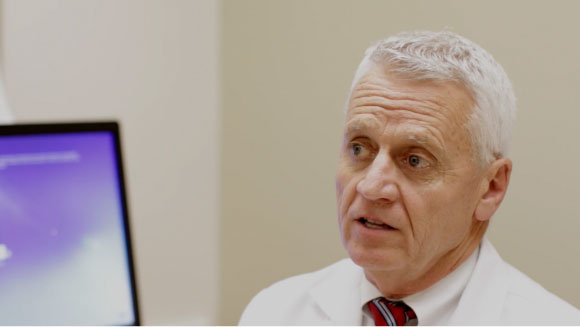 An image of a doctor looking at a computer monitor