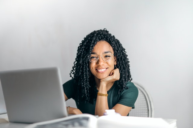 An image of a young woman working on her laptop