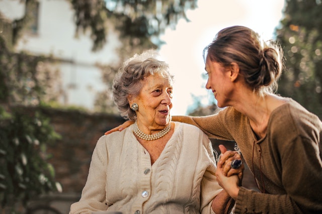 A young woman comforts her mother